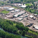 Aerial view of Columbia Steel, with a view of Portland's St. Johns neighborhood in the upper right, and the Columbia Slough wetlands in the foreground.