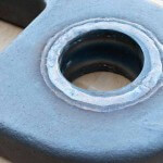 A Columbia Steel manganese steel bushing welded into one of our XtraLife® end links