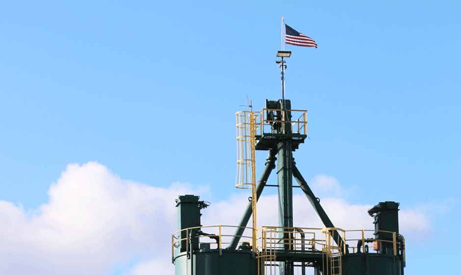 US flag flying over sand towers at Columbia Steel