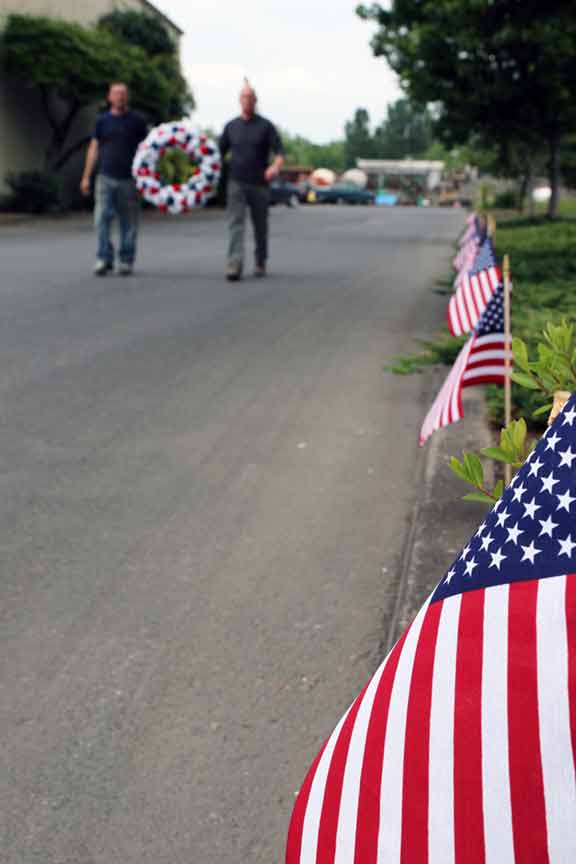 Employees bring a memorial wreath to Columbia Steel's remembrance gathering on Memorial Day